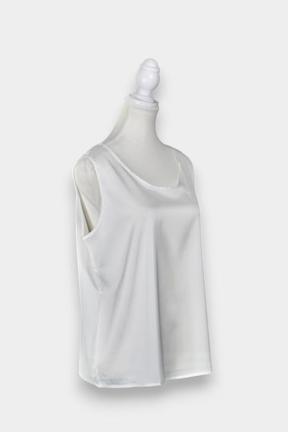 Women's white sleeveless silk top with a scoop neckline on a mannequin.