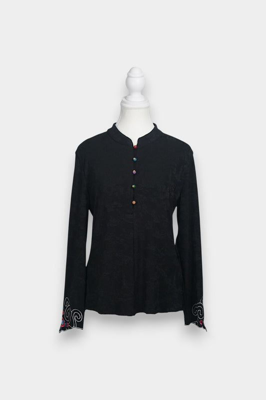Long sleeve black mandarin collar blouse made from silk spandex blend with embroidery details.