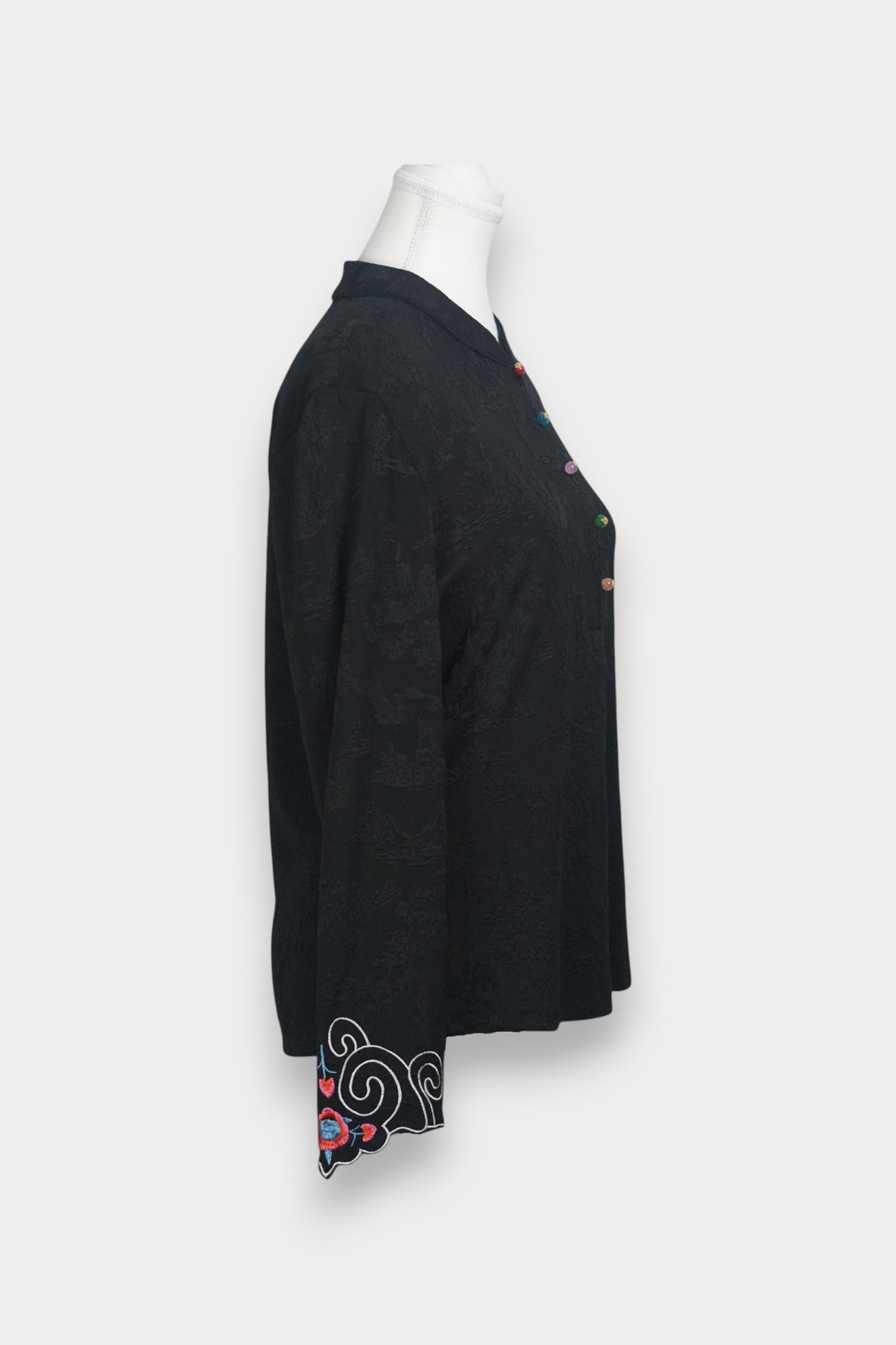 Long sleeve black mandarin collar blouse made from silk spandex blend with embroidery details.