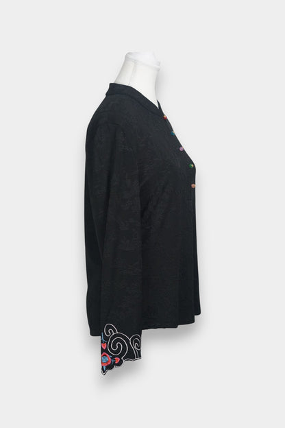 Long sleeve black mandarin collar blouse made from silk spandex blend with embroidery details.