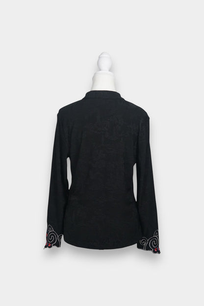 Long sleeve black mandarin collar blouse made from silk spandex blend with embroidery details.