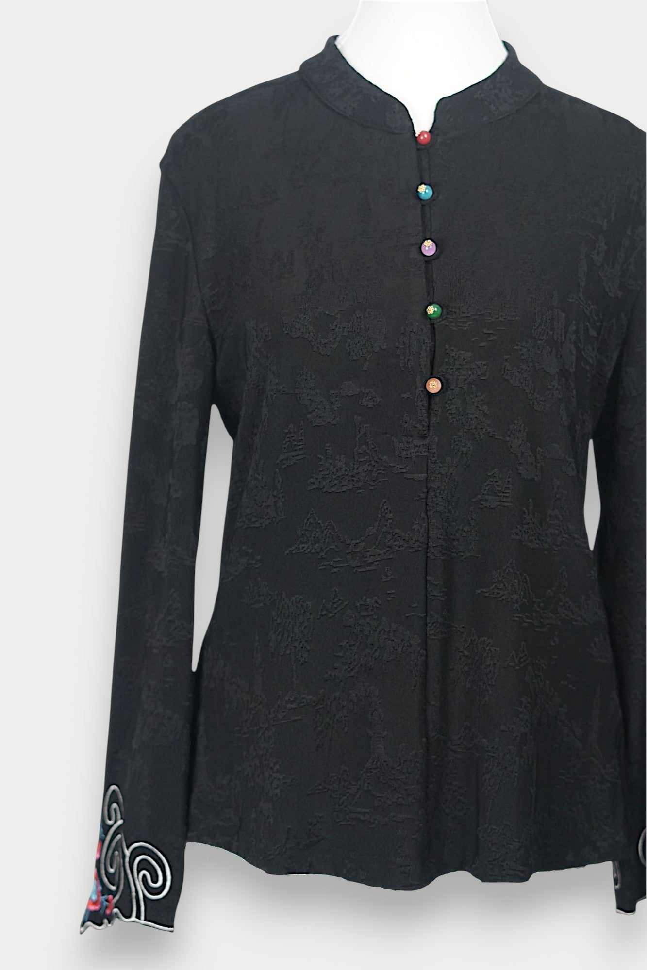 Long sleeve black mandarin collar blouse made from silk spandex blend with embroidery details.