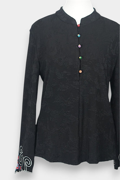 Long sleeve black mandarin collar blouse made from silk spandex blend with embroidery details.
