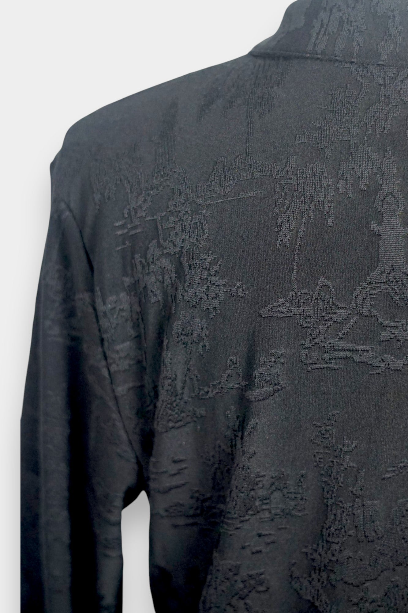 Long sleeve black mandarin collar blouse made from silk spandex blend with embroidery details.