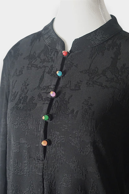 Long sleeve black mandarin collar blouse made from silk spandex blend with embroidery details.