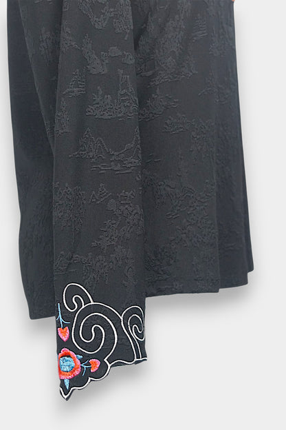 Long sleeve black mandarin collar blouse made from silk spandex blend with embroidery details.