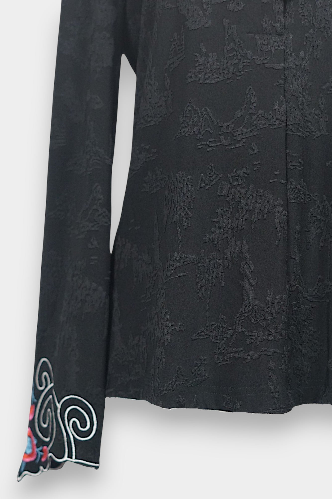 Long sleeve black mandarin collar blouse made from silk spandex blend with embroidery details.