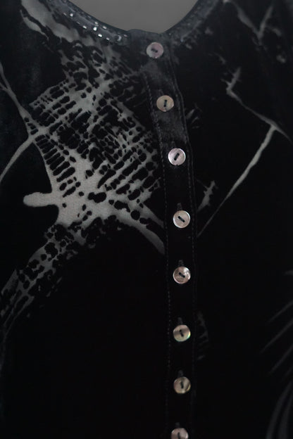 Women's black silk Henley top with grey abstract sketch patterns, buttons, and drawstring hem on a mannequin.