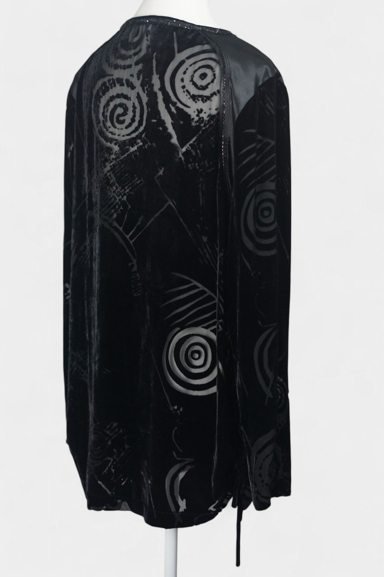 Women's black silk Henley top with grey abstract sketch patterns, buttons, and drawstring hem on a mannequin.