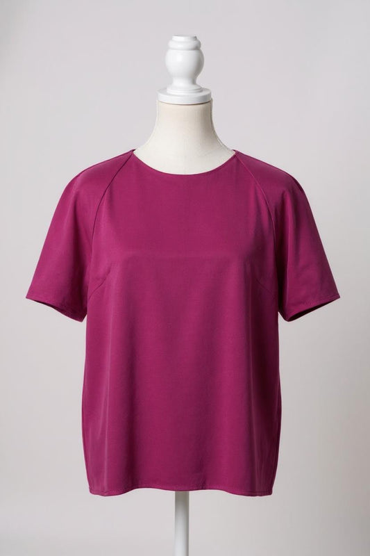 Women's short-sleeve magenta silk top with a round neck and raglan sleeves on a mannequin.
