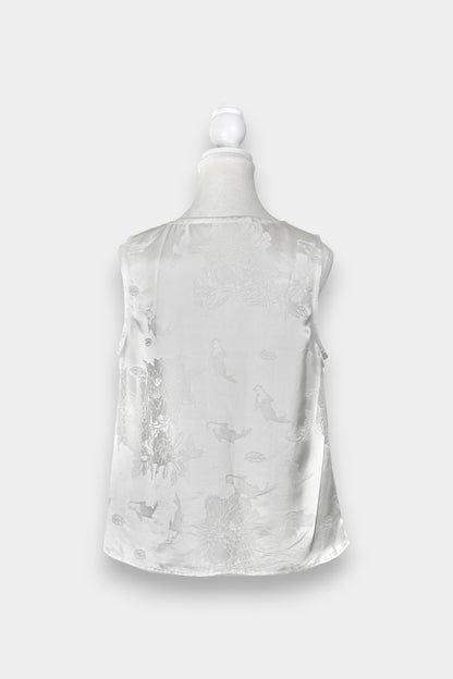 Women's white silk V-neck top with subtle woven koi fish and lotus flower jacquard patterns.