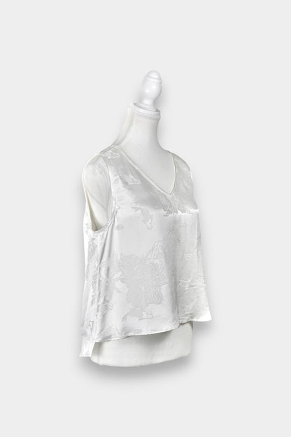 Women's white silk V-neck top with subtle woven koi fish and lotus flower jacquard patterns.