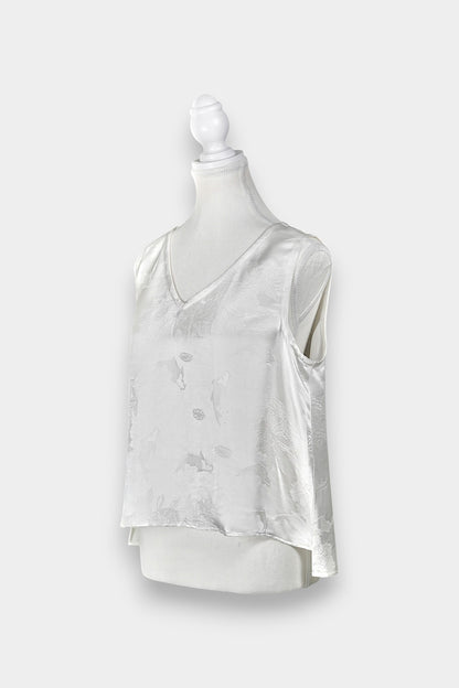 Women's white silk V-neck top with subtle woven koi fish and lotus flower jacquard patterns.