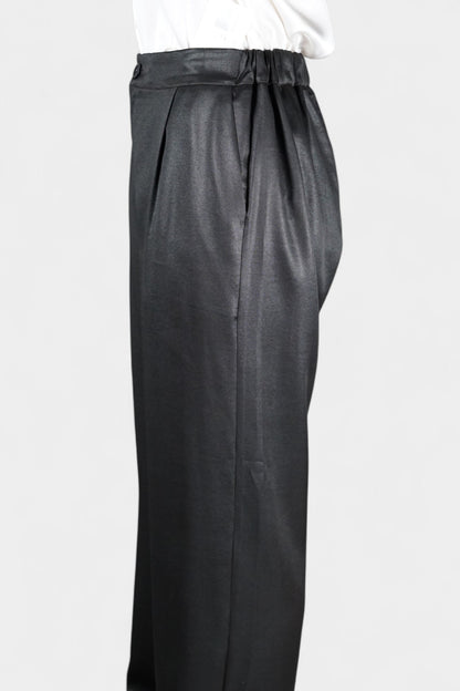 Black wide-leg silk trousers with side pockets and a luxurious satin finish.