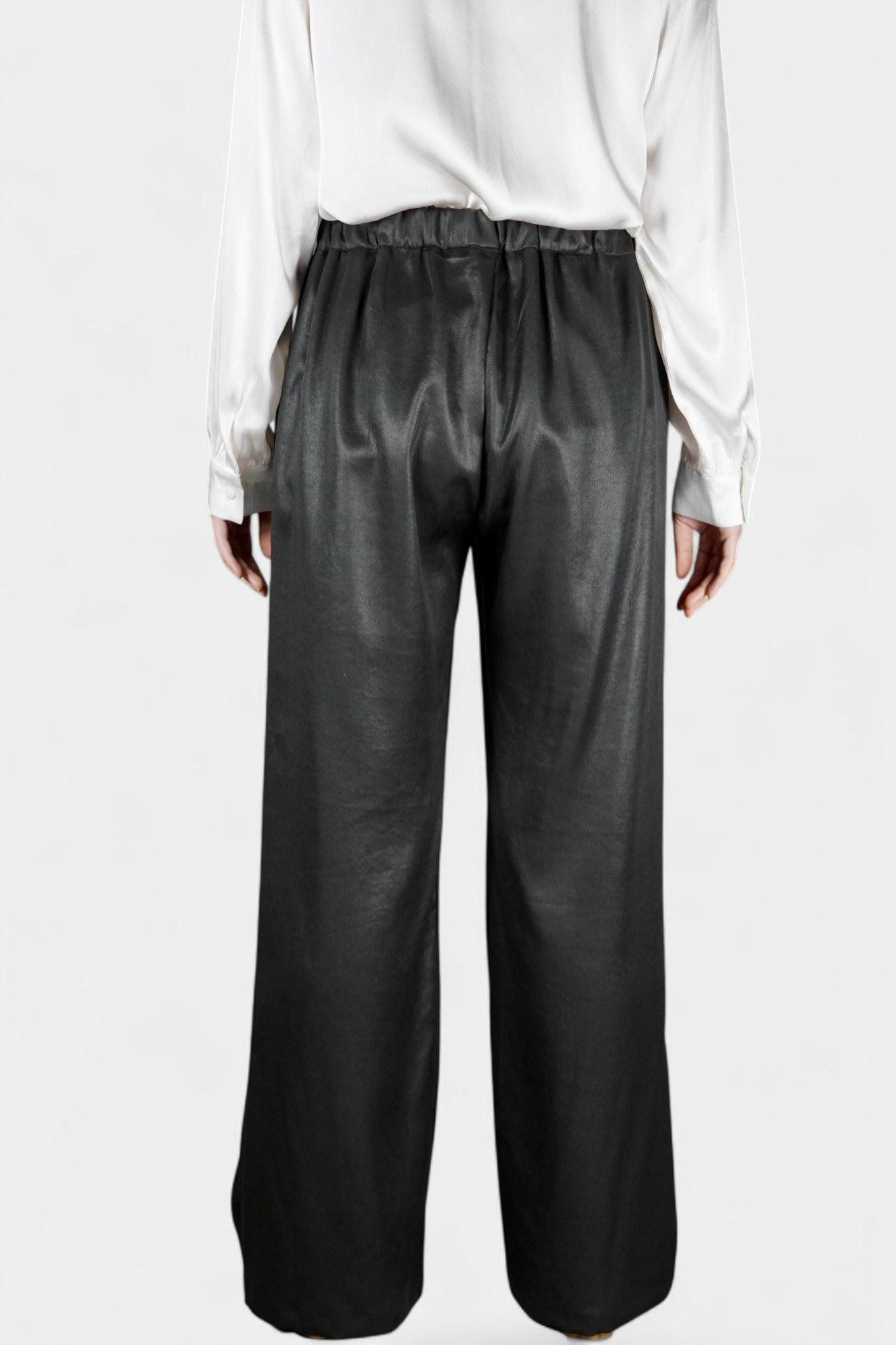 Black wide-leg silk trousers with side pockets and a luxurious satin finish.