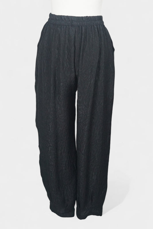 Black textured silk lantern pants with high elastic waistband and tapered ankles