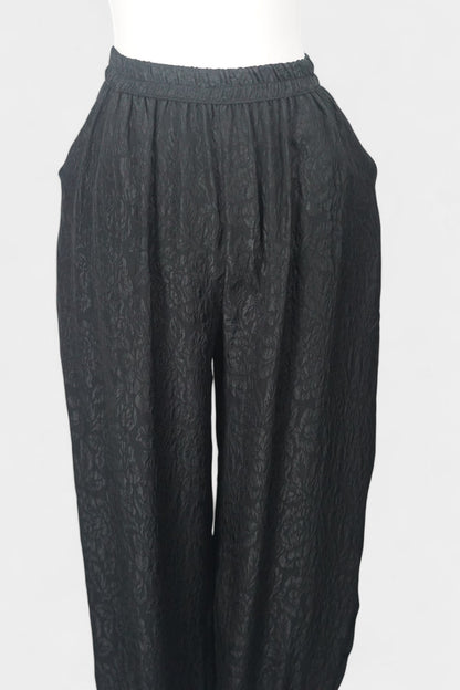 Black textured silk lantern pants with high elastic waistband and tapered ankles