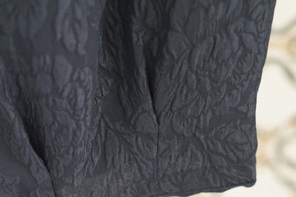 Black textured silk lantern pants with high elastic waistband and tapered ankles