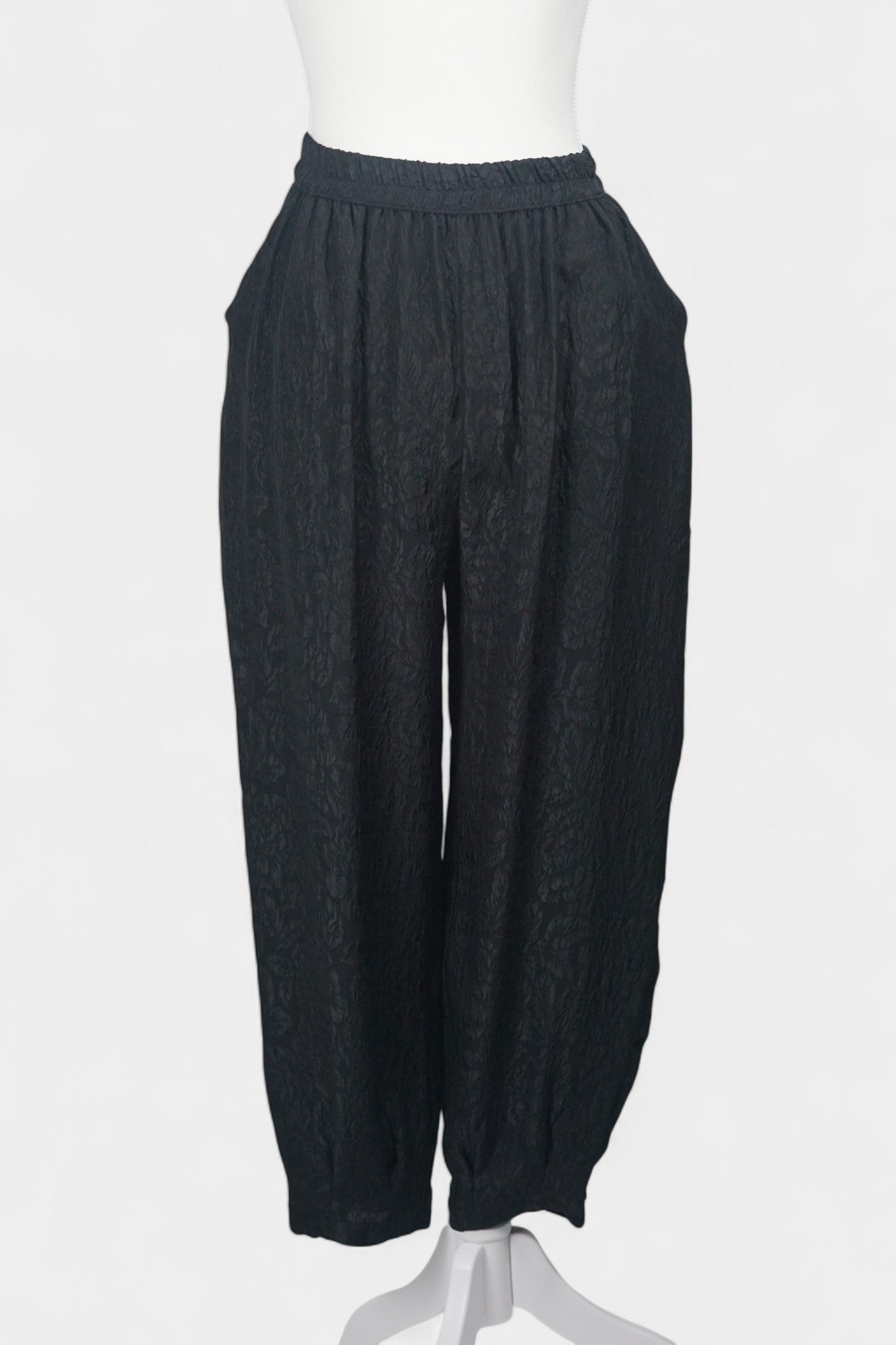 Black textured silk lantern pants with high elastic waistband and tapered ankles