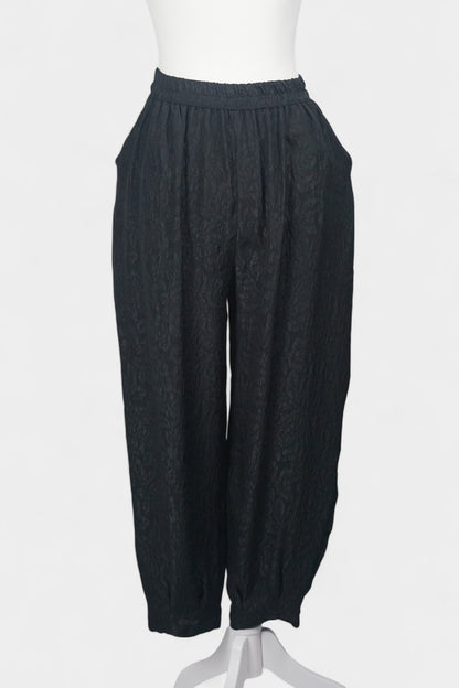 Black textured silk lantern pants with high elastic waistband and tapered ankles