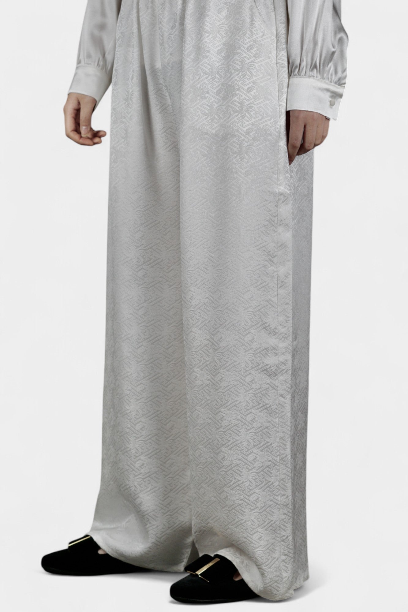 Pearl white wide-leg silk trousers featuring a subtle geometric jacquard pattern and elastic waistband