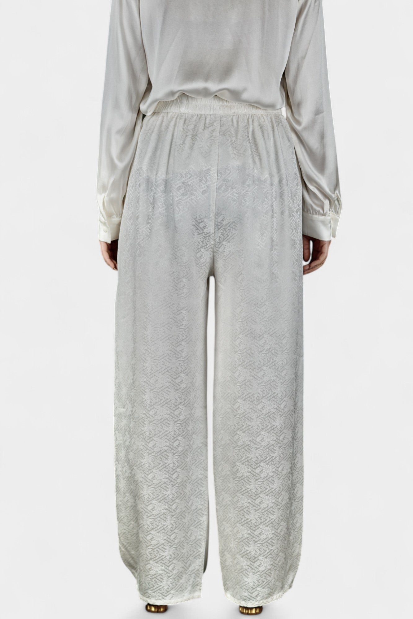 Pearl white wide-leg silk trousers featuring a subtle geometric jacquard pattern and elastic waistband