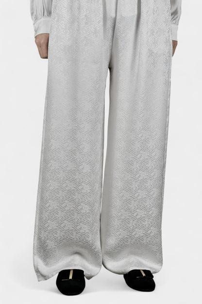 Pearl white wide-leg silk trousers featuring a subtle geometric jacquard pattern and elastic waistband