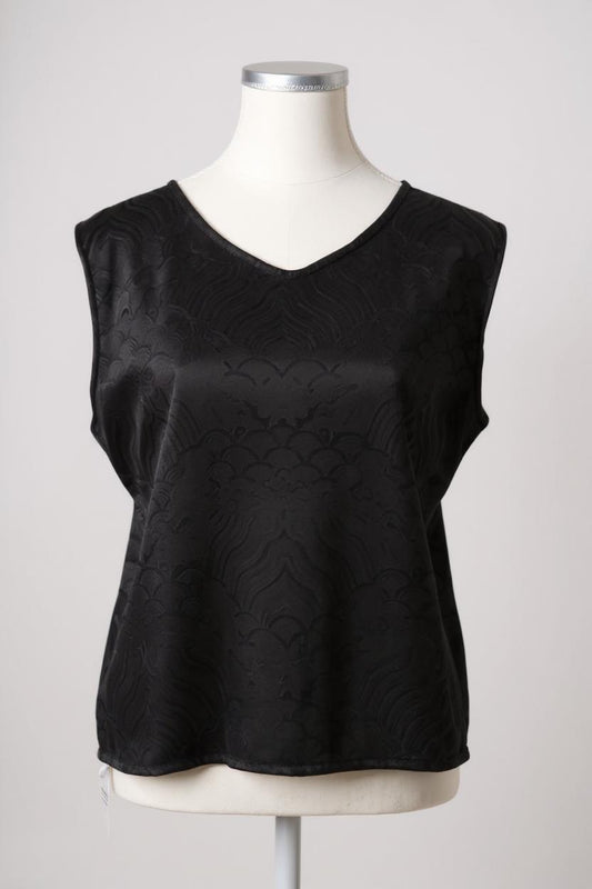 Black side of a reversible women's silk vest featuring a textured wave jacquard pattern and V-neckline
