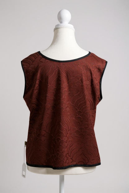 Rust red side of a reversible Gambiered Guangdong Gauze silk vest with black piping trim and traditional cloud pattern