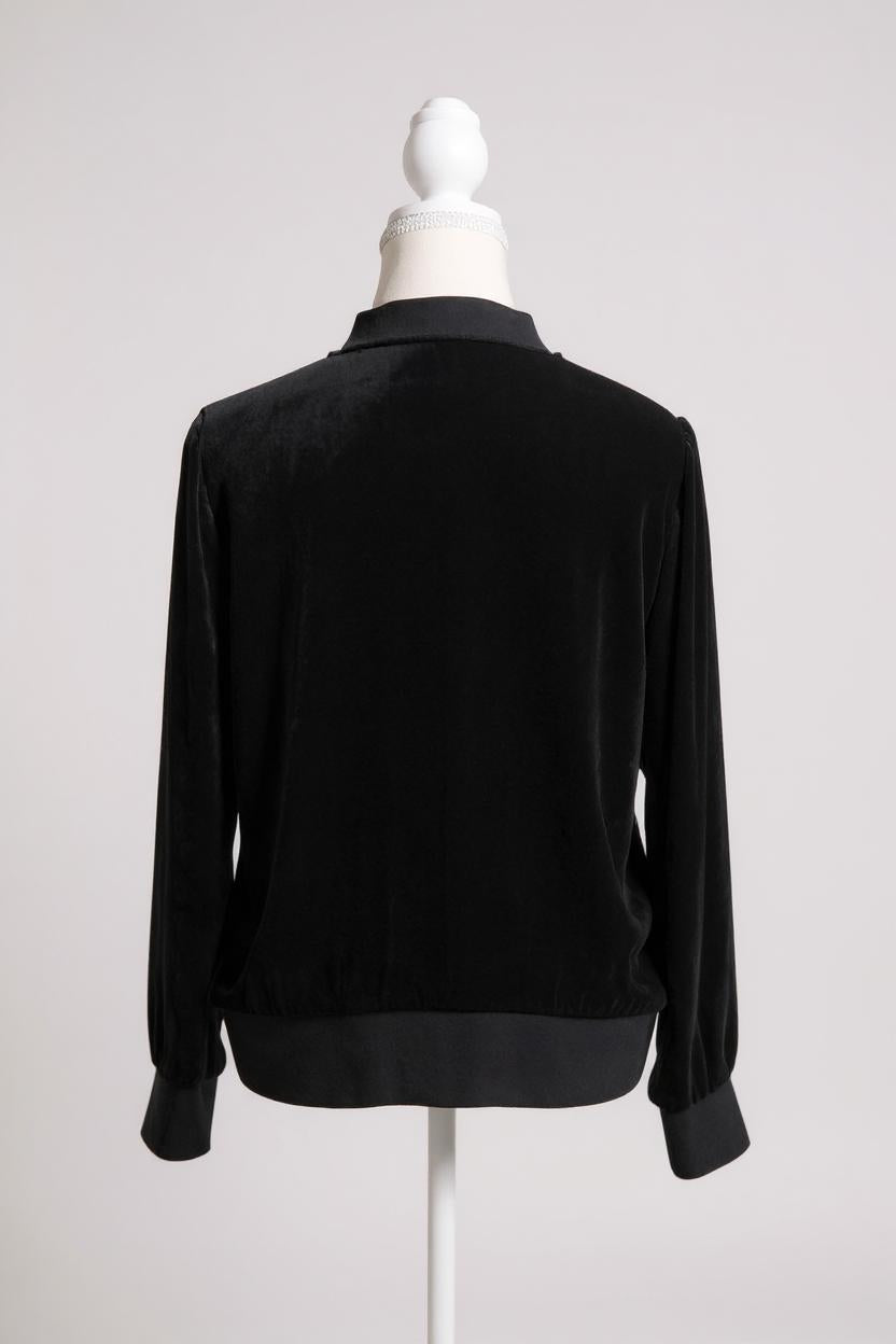 Women's black silk velvet jacket featuring a button-down front, ribbed stand collar, and ribbed cuffs and hem on a mannequin.