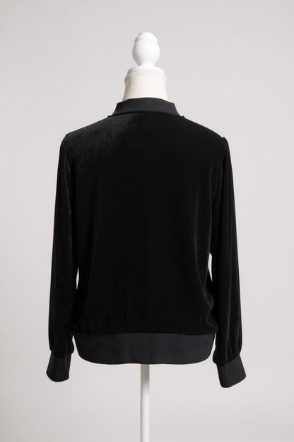 Women's black silk velvet jacket featuring a button-down front, ribbed stand collar, and ribbed cuffs and hem on a mannequin.