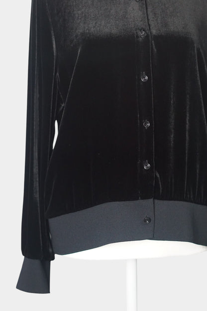 Women's black silk velvet jacket featuring a button-down front, ribbed stand collar, and ribbed cuffs and hem on a mannequin.