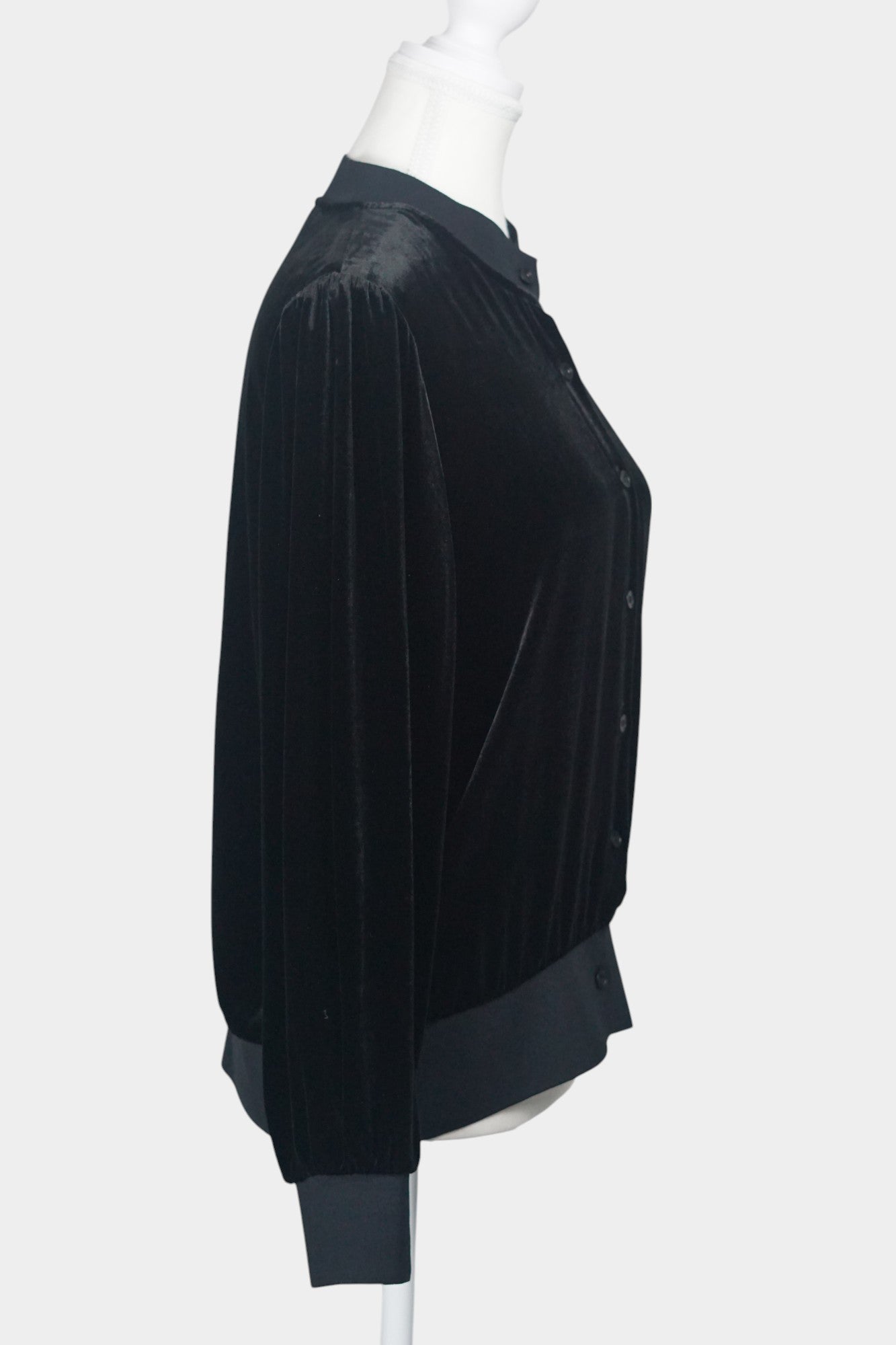 Women's black silk velvet jacket featuring a button-down front, ribbed stand collar, and ribbed cuffs and hem on a mannequin.