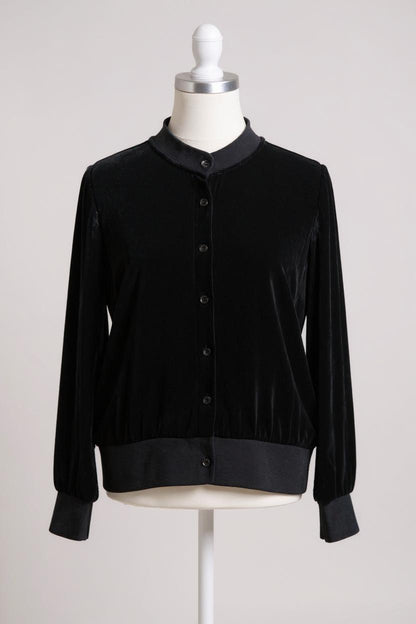 Women's black silk velvet jacket featuring a button-down front, ribbed stand collar, and ribbed cuffs and hem on a mannequin.