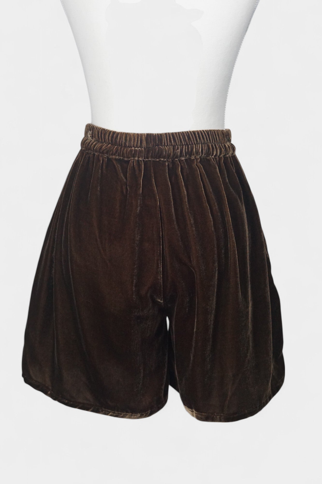 Luxe chocolate silk velvet shorts featuring soft texture and gathered waist.