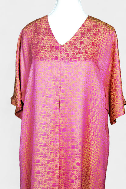 Women's pink and gold Song Brocade dress with a geometric lattice pattern and V-neckline on a mannequin