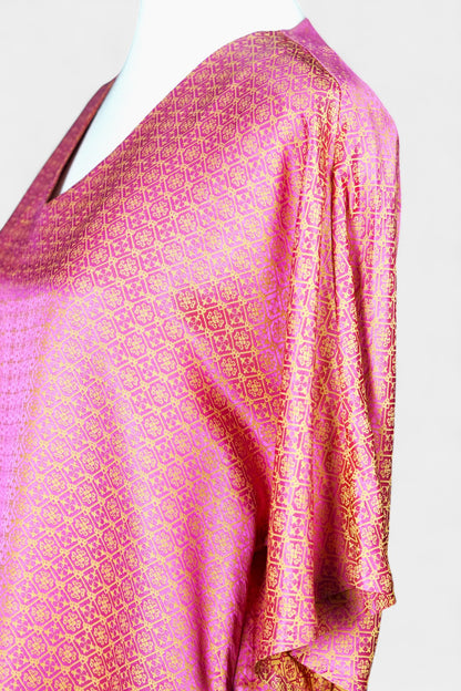 Women's pink and gold Song Brocade dress with a geometric lattice pattern and V-neckline on a mannequin