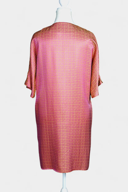 Women's pink and gold Song Brocade dress with a geometric lattice pattern and V-neckline on a mannequin