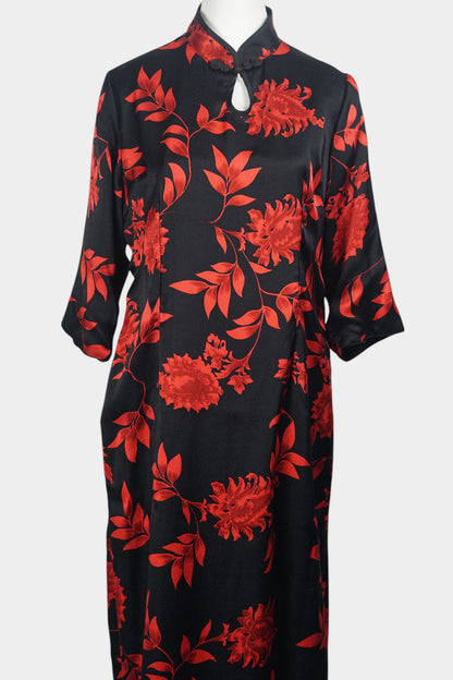 Traditional Chinese style midi dress in lustrous black fabric, adorned with vibrant red floral motifs and a teardrop cutout at the neck
