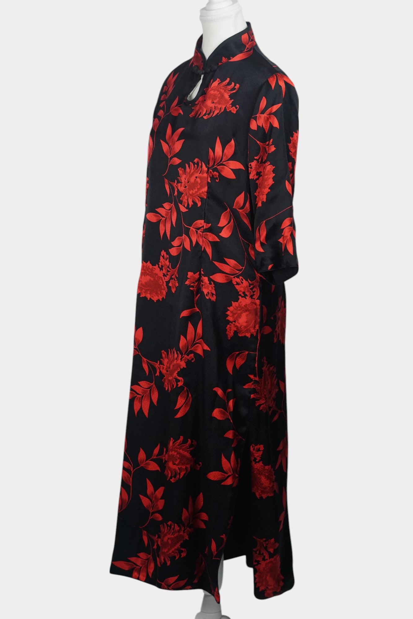 Traditional Chinese style midi dress in lustrous black fabric, adorned with vibrant red floral motifs and a teardrop cutout at the neck