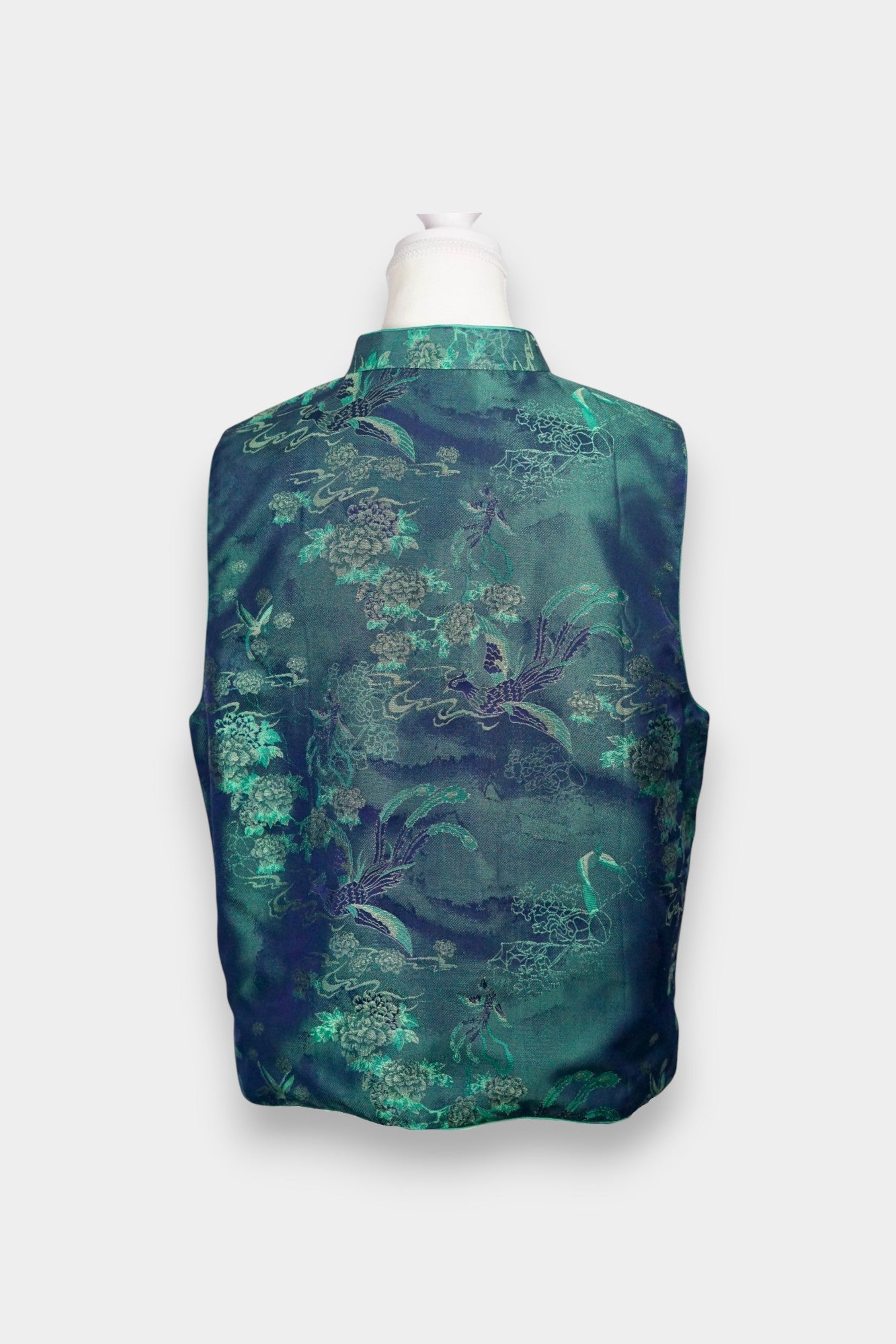 Traditional Chinese Tang suit vest featuring intricate cloud and bird patterns in teal and navy.