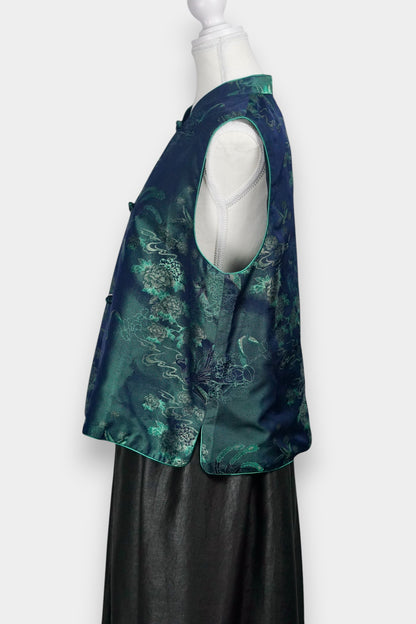 Traditional Chinese Tang suit vest featuring intricate cloud and bird patterns in teal and navy.