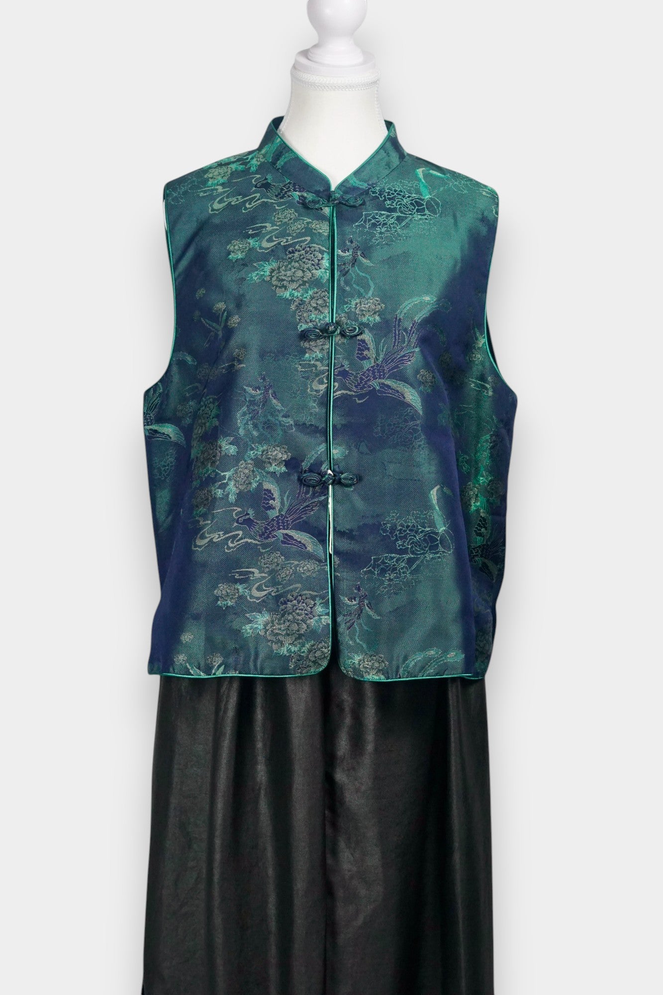 Traditional Chinese Tang suit vest featuring intricate cloud and bird patterns in teal and navy.