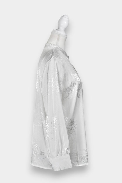 Lustrous ivory Song Jin top adorned with subtle floral patterns and a side-fastening front