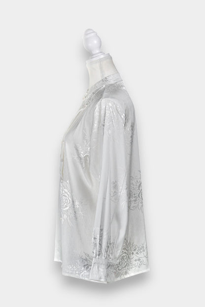 Lustrous ivory Song Jin top adorned with subtle floral patterns and a side-fastening front
