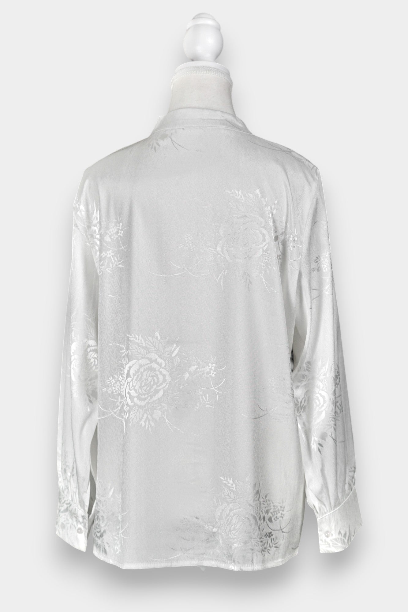 Lustrous ivory Song Jin top adorned with subtle floral patterns and a side-fastening front
