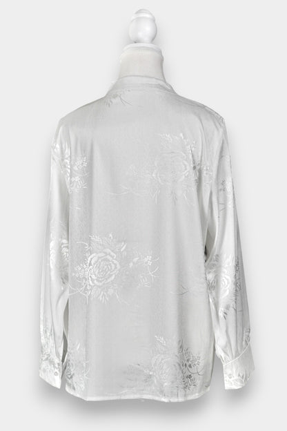 Lustrous ivory Song Jin top adorned with subtle floral patterns and a side-fastening front