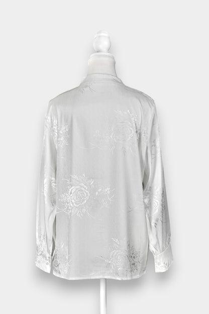 Lustrous ivory Song Jin top adorned with subtle floral patterns and a side-fastening front