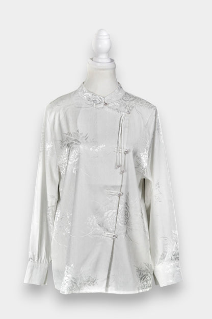 Lustrous ivory Song Jin top adorned with subtle floral patterns and a side-fastening front