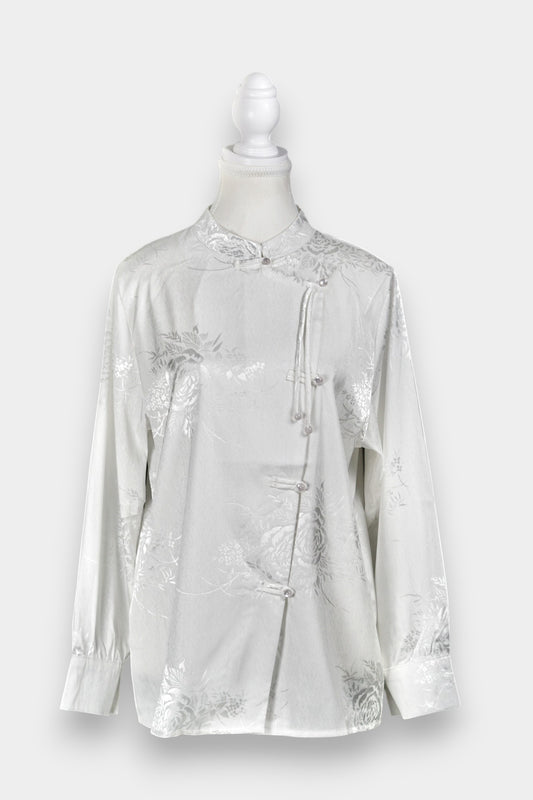 Lustrous ivory Song Jin top adorned with subtle floral patterns and a side-fastening front